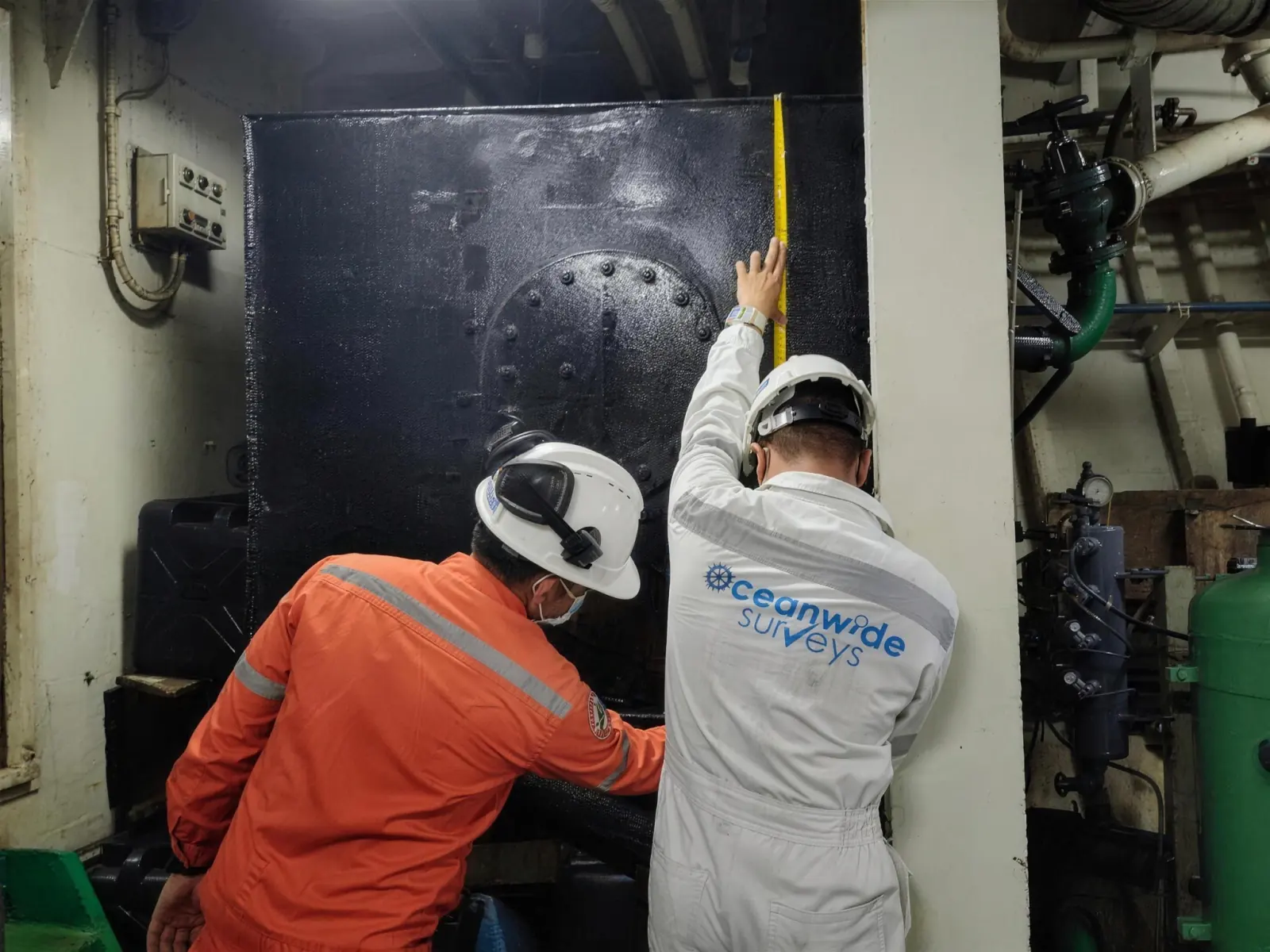 Oceanwide Surveys inspectors examine a machinery tank